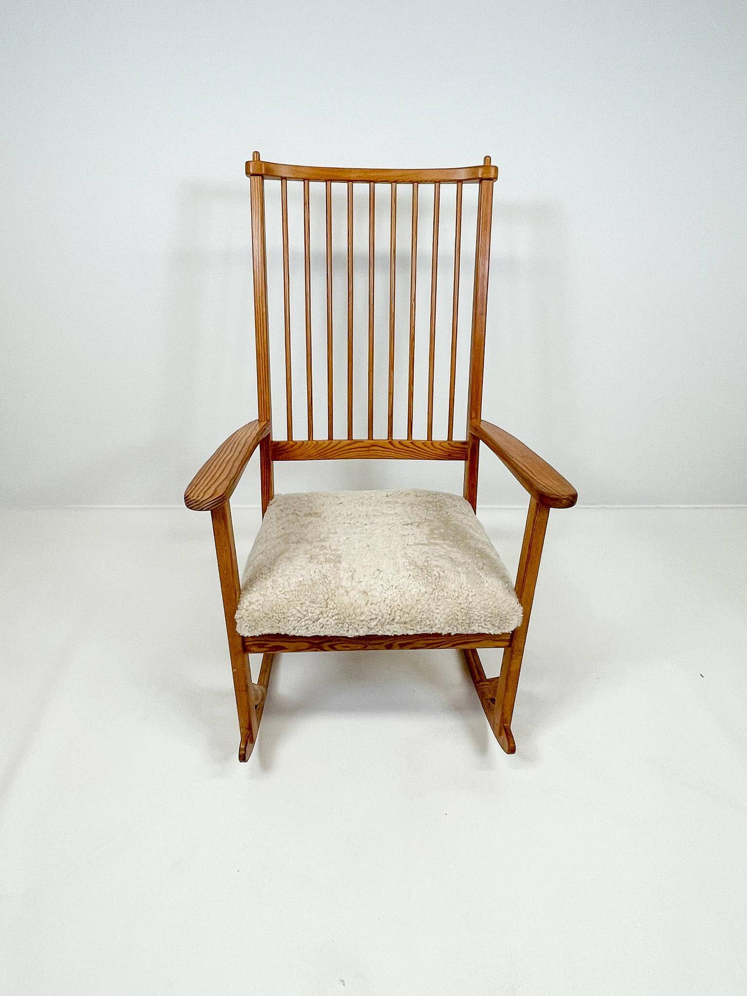 Mid-century rocking chair in pine and sheepskin by Yngve Ekström, Sweden.