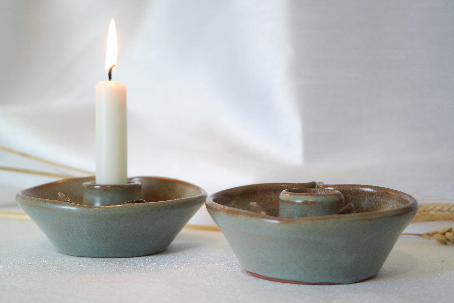 Pair of cellar rat candle holders in glazed sandstone