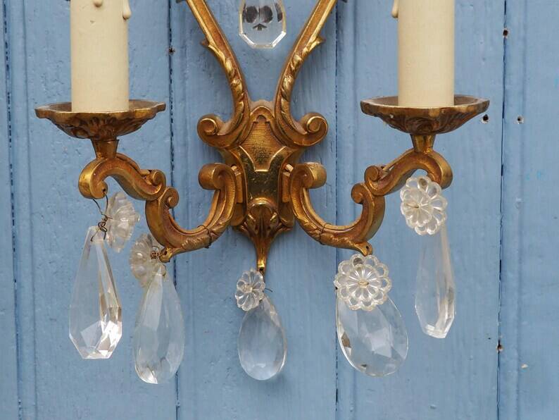 French antique Louis XV style twin arm wall sconces in bronze with crystals.