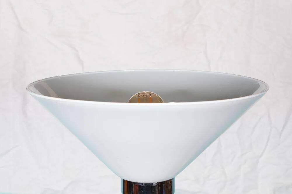 Vintage floor lamp in milky glass and chrome, minimalist uplight lighting.