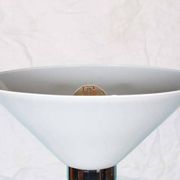 Vintage floor lamp in milky glass and chrome, minimalist uplight lighting.
