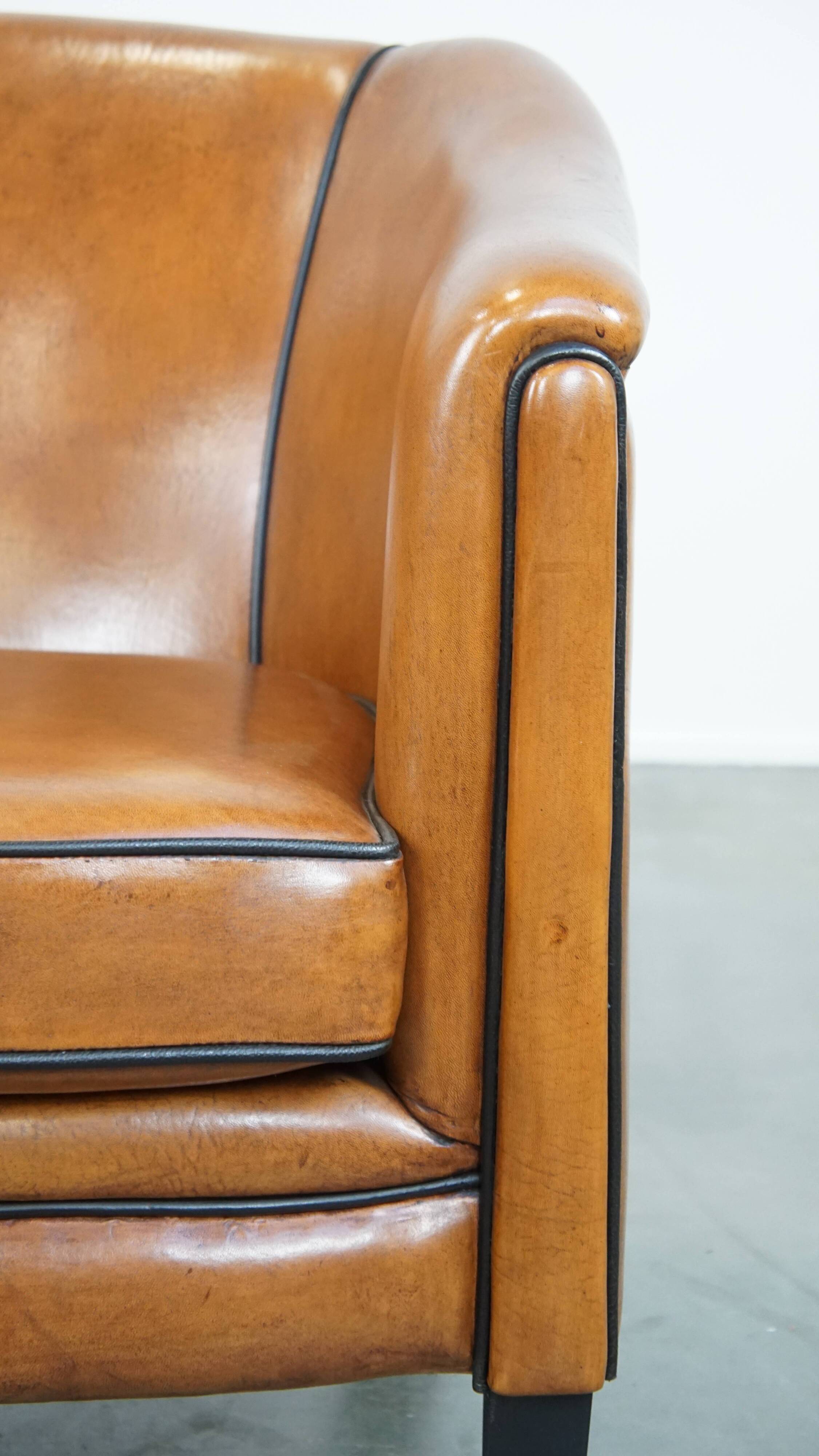 Sheep leather club chair finished with black piping