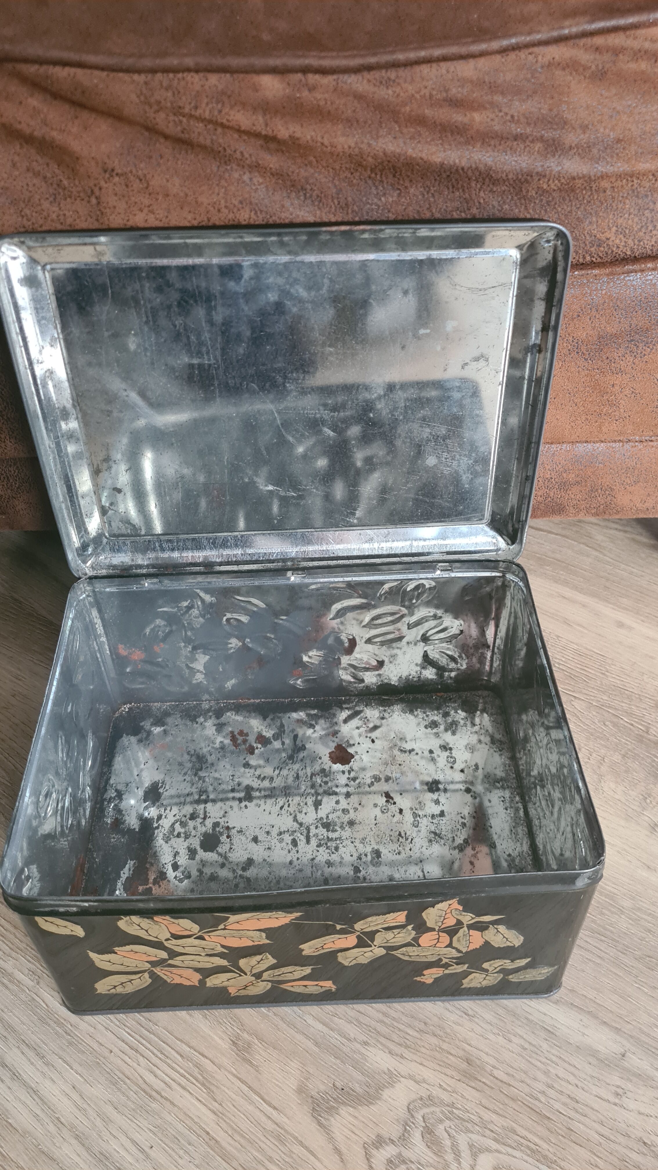 Old black metal box and flowers at the beginning of the century