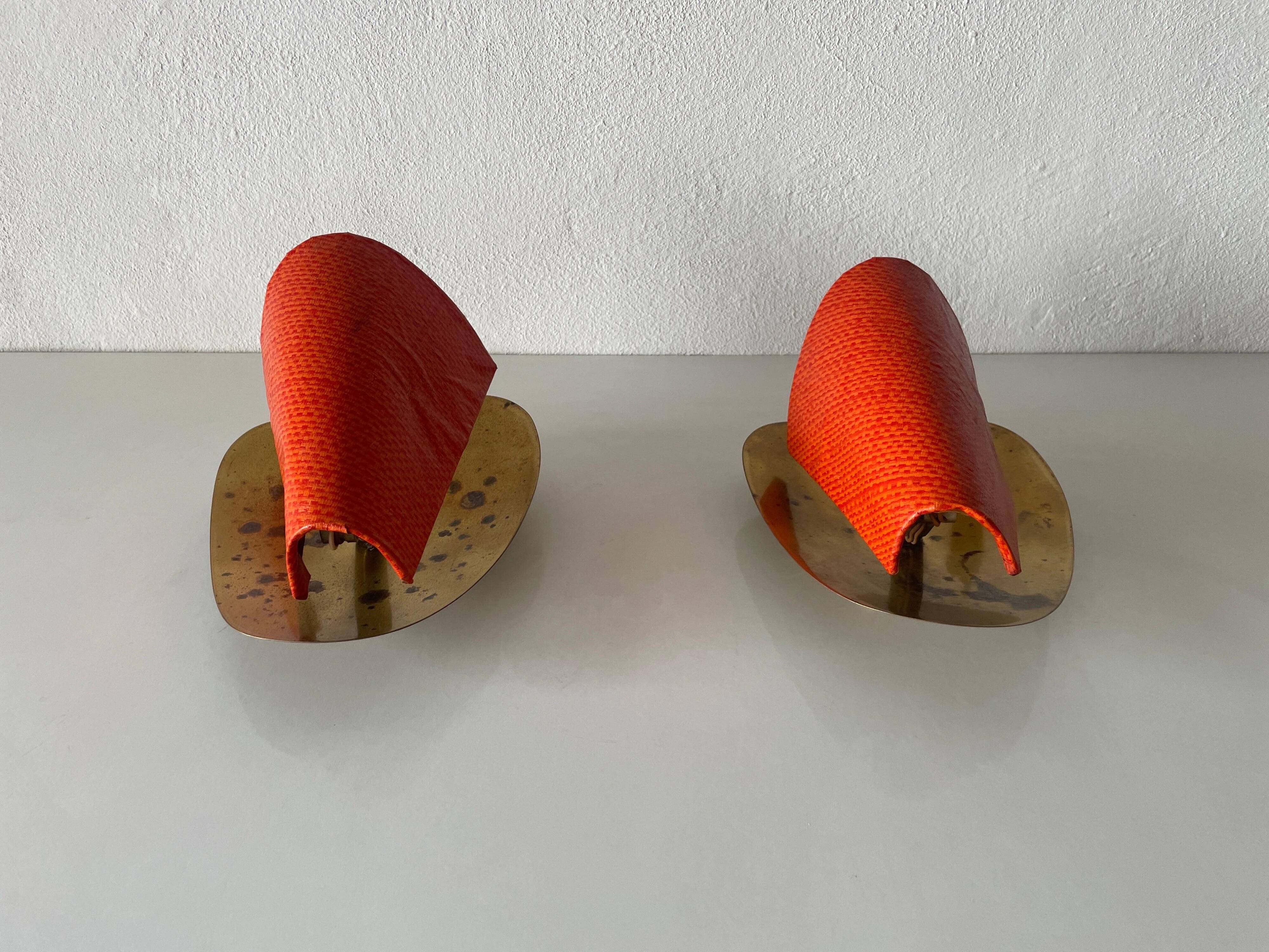 Pair of orange plexiglass and curved brass wall lights, 1950s, Germany