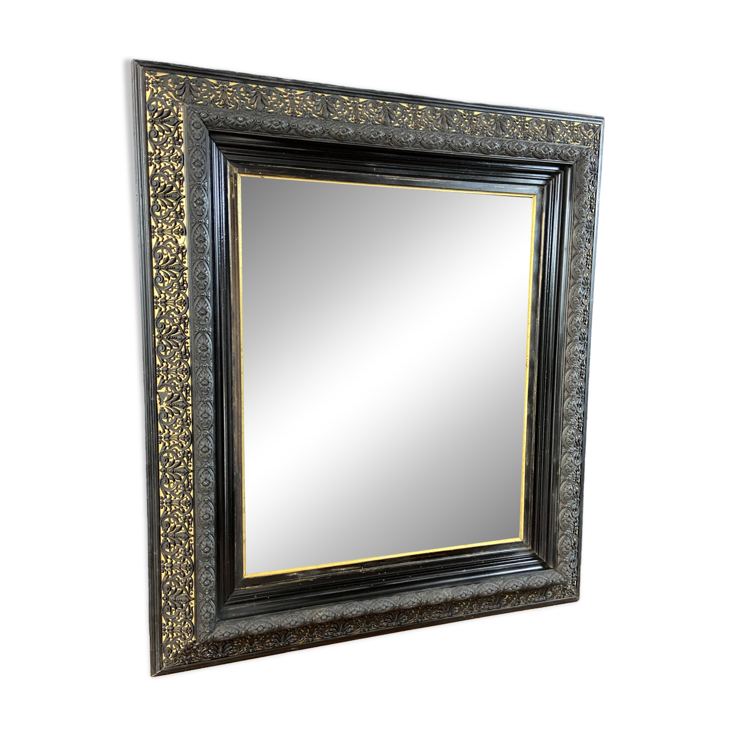 19th-century mirror Napoleon III in blackened wood on a gold background.