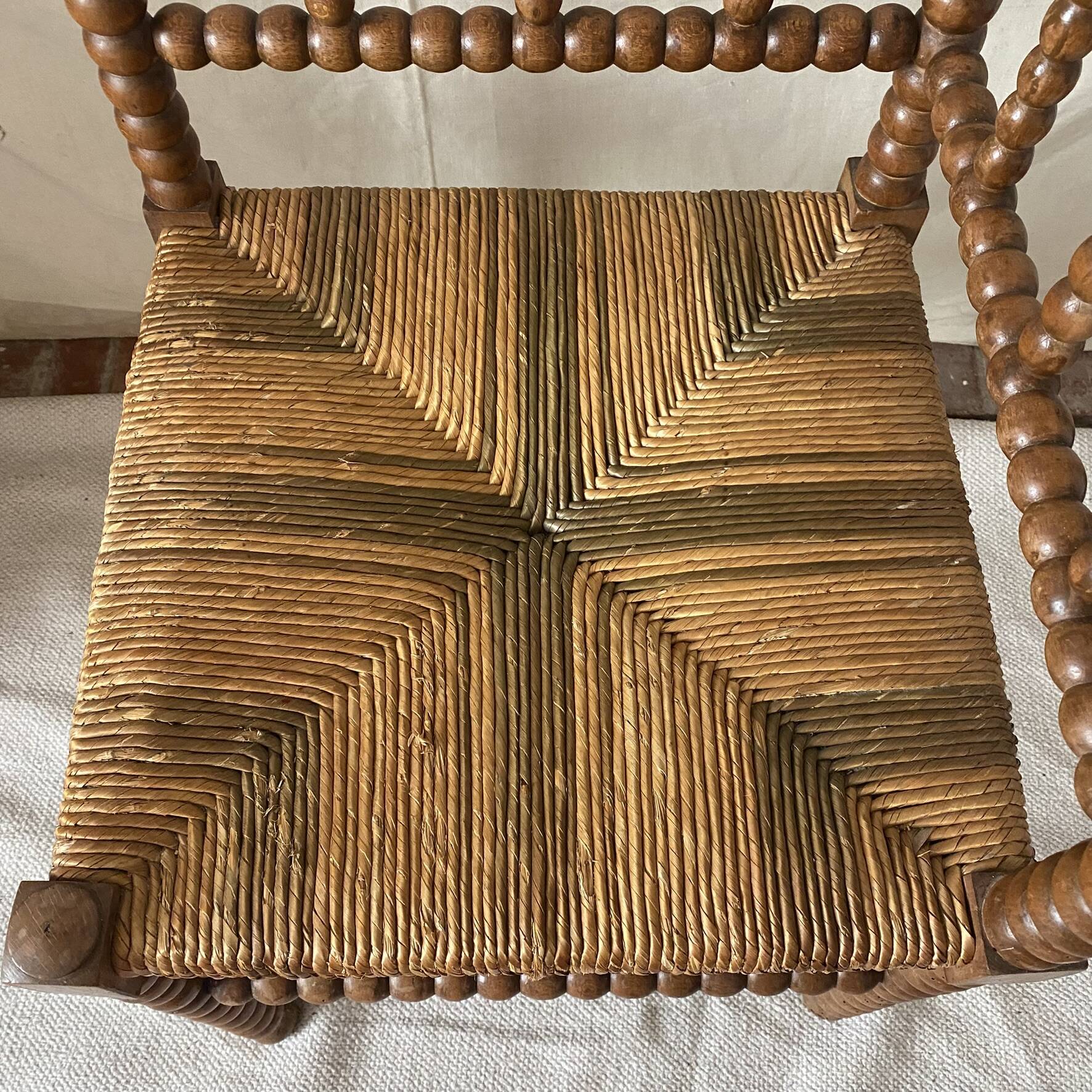 Corner chair in straw and turned wood, fireside chair.
