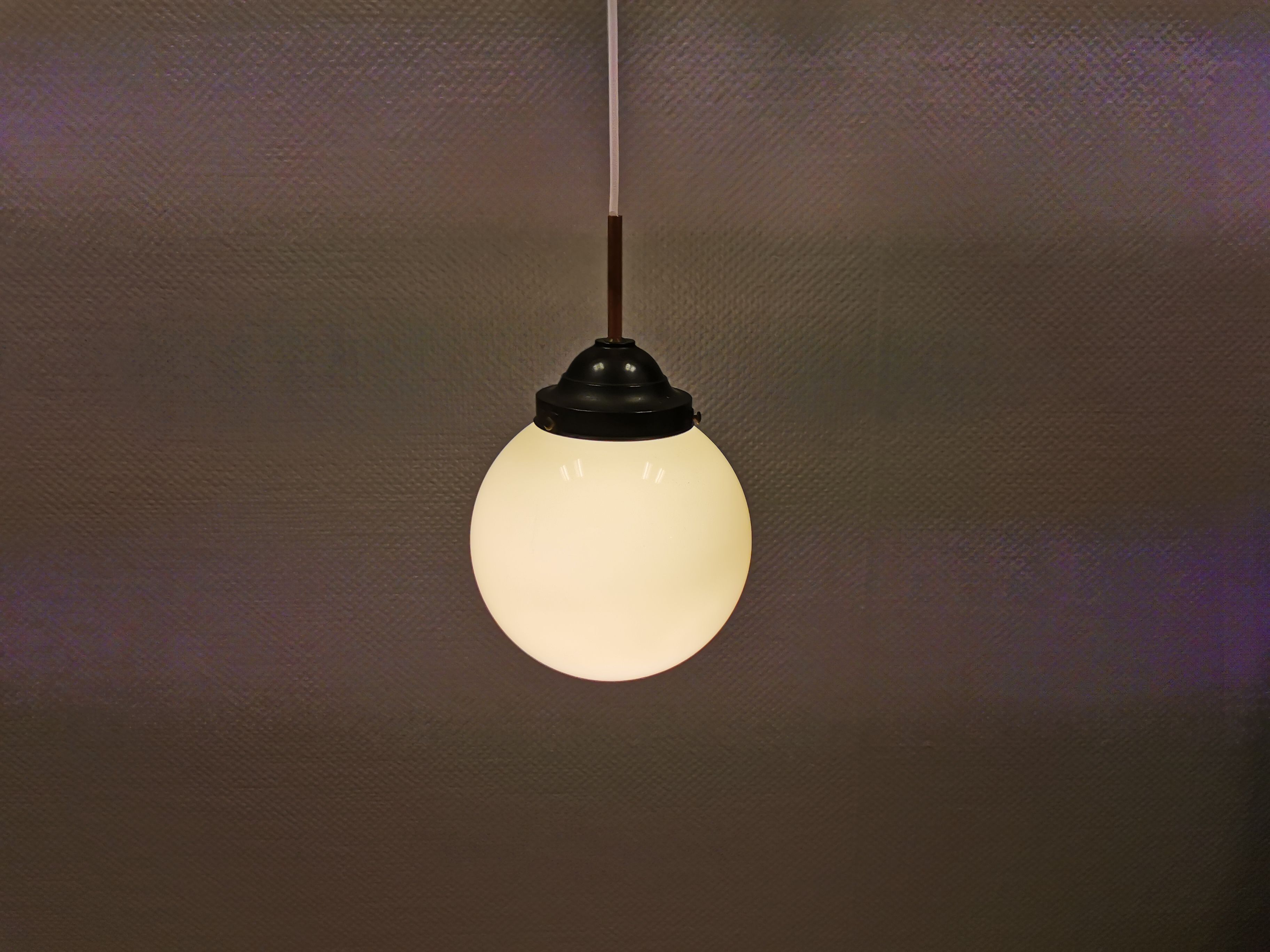 Small Art Deco hanging lamp in cream coloured glass and bakelite top.