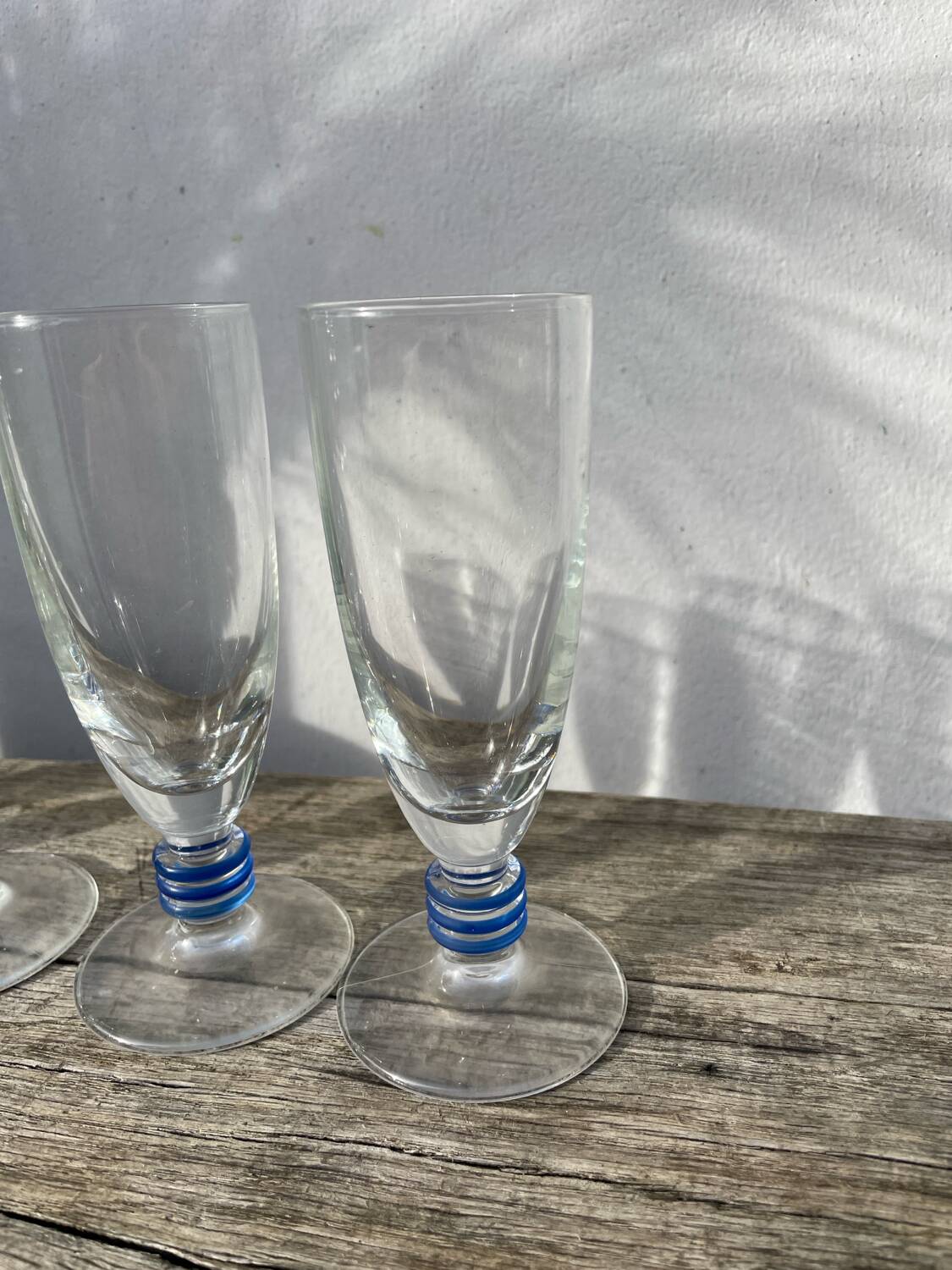 6 clear champagne flutes with blue stems, designer style