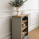 Green-grey library, wooden shelf and shelves in natural wood.