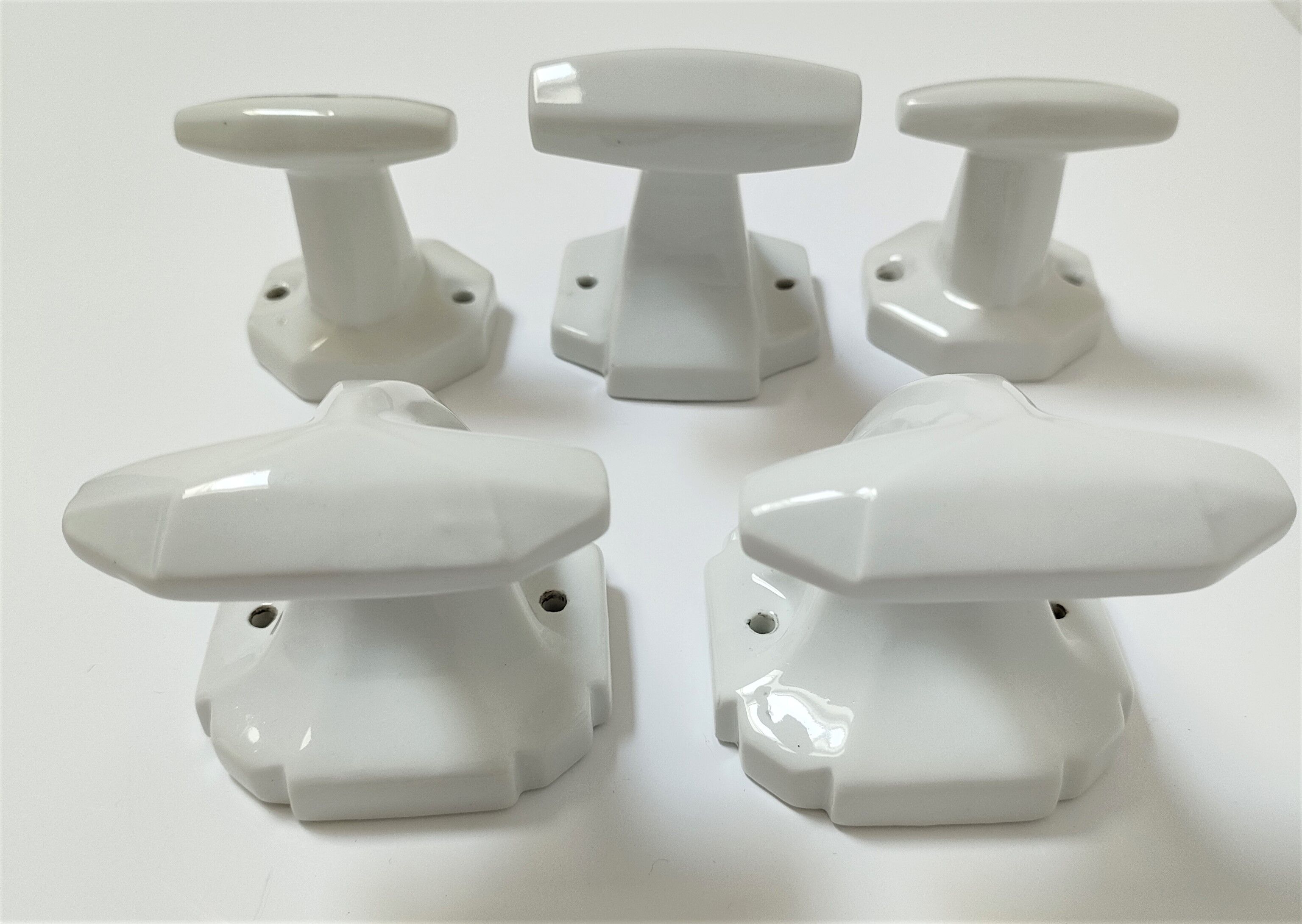 Five art deco white porcelain hooks