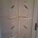 Cream and brass corner bakery shelf in wrought iron