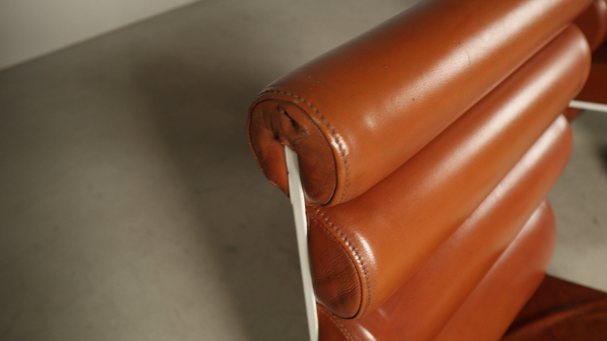 Pair of sculptural cognac leather armchairs, 1970s