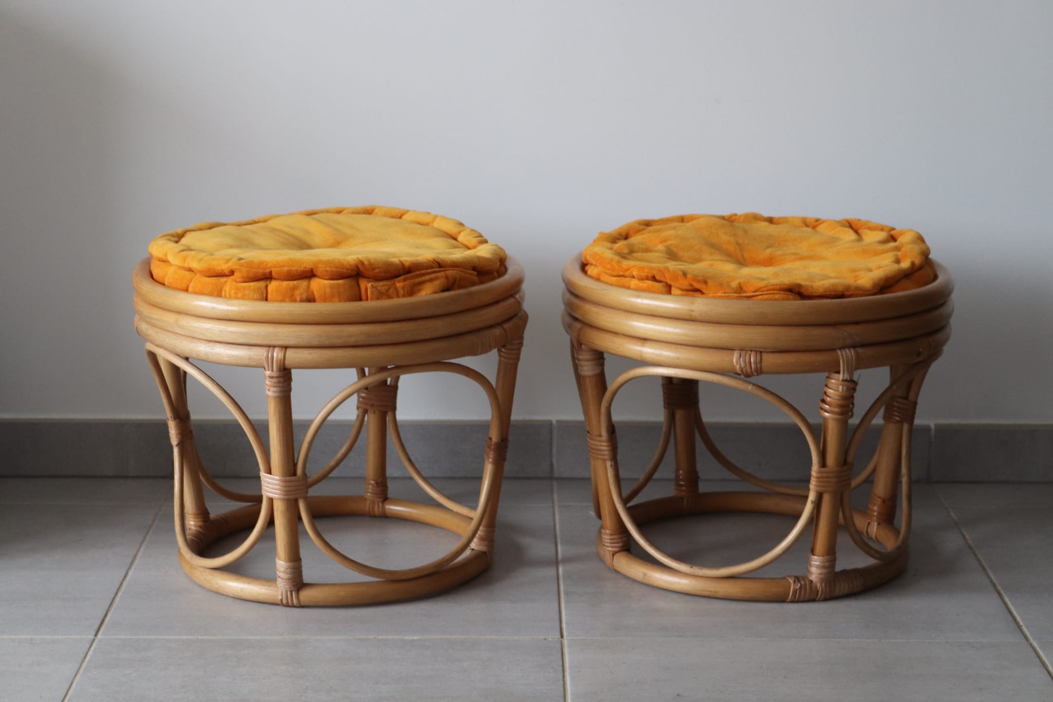 Two vintage rattan ottomans