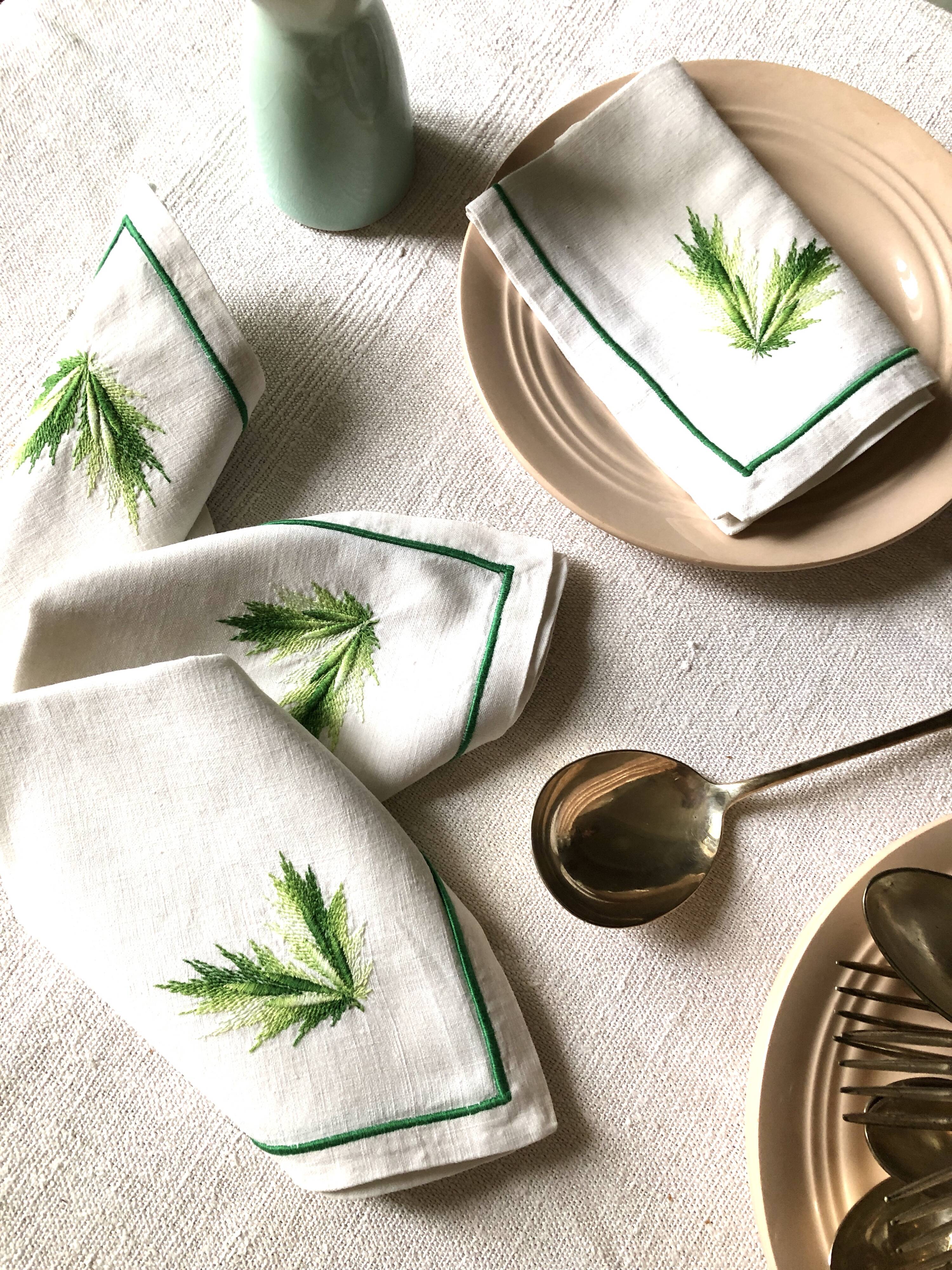 Series of four embroidered linen napkins