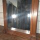 Bevelled mirror in carved wood