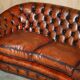 Curved Chesterfield canapé in hand-dyed vintage leather, fully restored.