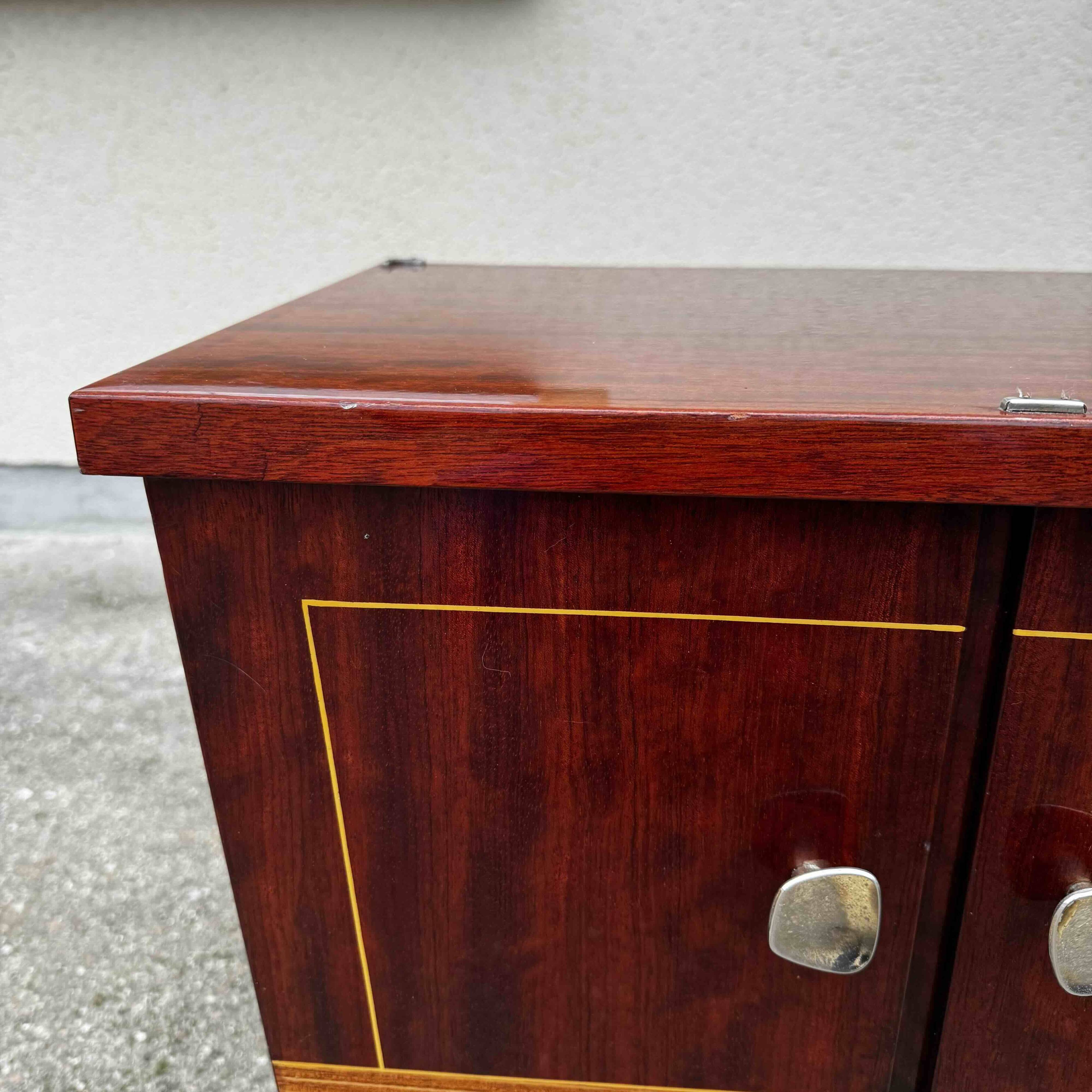 1950s bedside table in varnished wood veneer and brass.