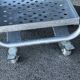 Four-wheeled dessert trolley with 4 perforated metal shelves.