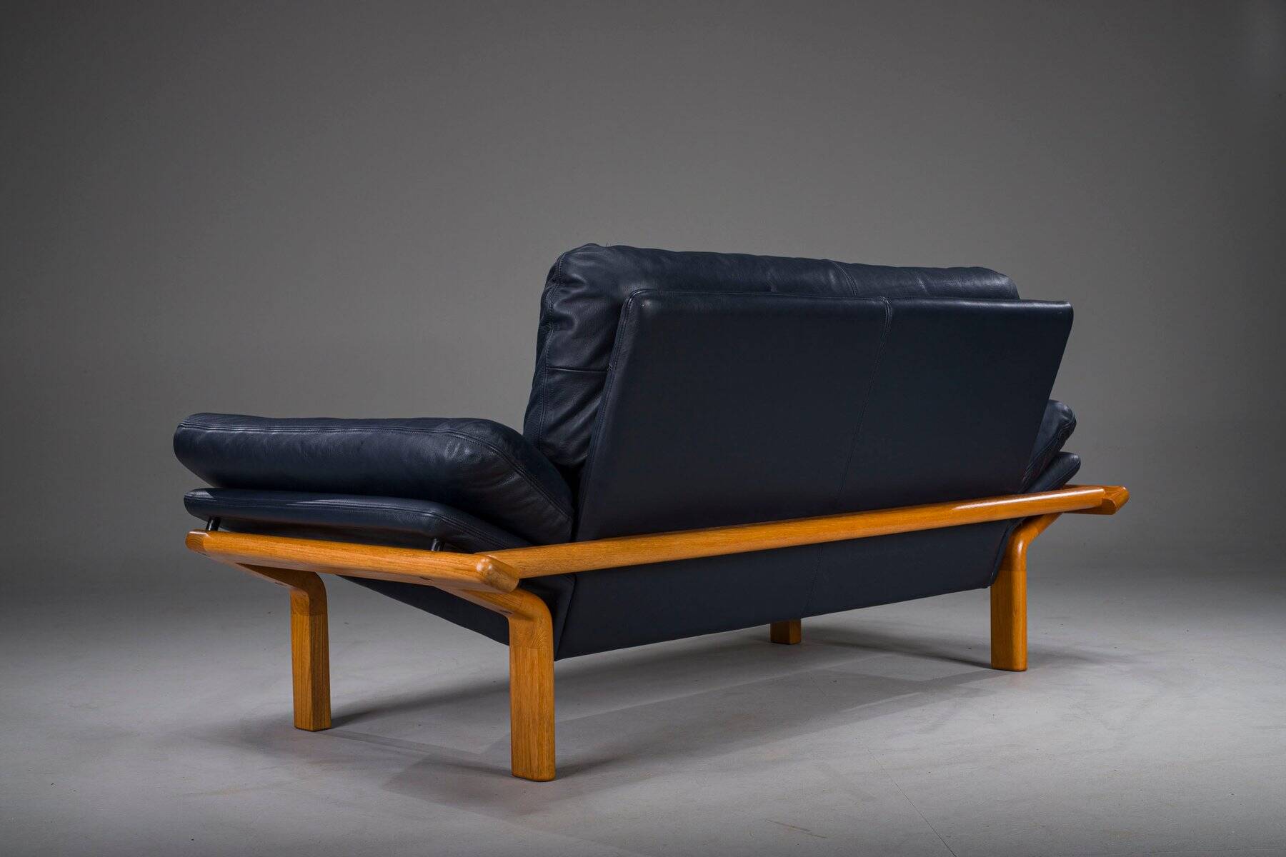 Danish teak and navy blue leather 2-seater sofa from Komfort, 1970s