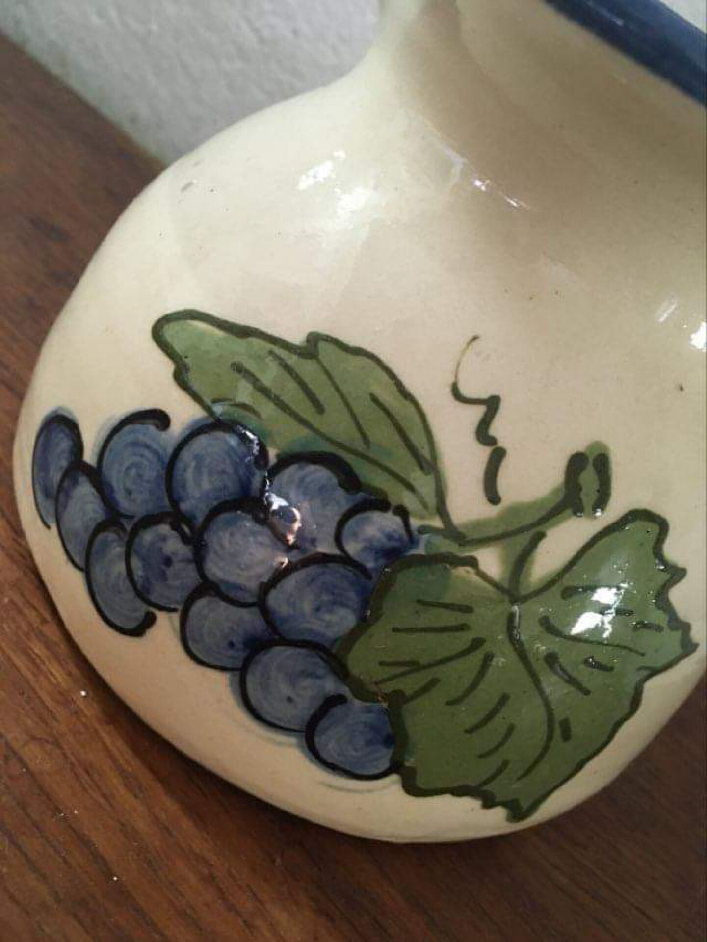 Terracotta jug with grape decoration.