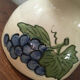 Terracotta jug with grape decoration.