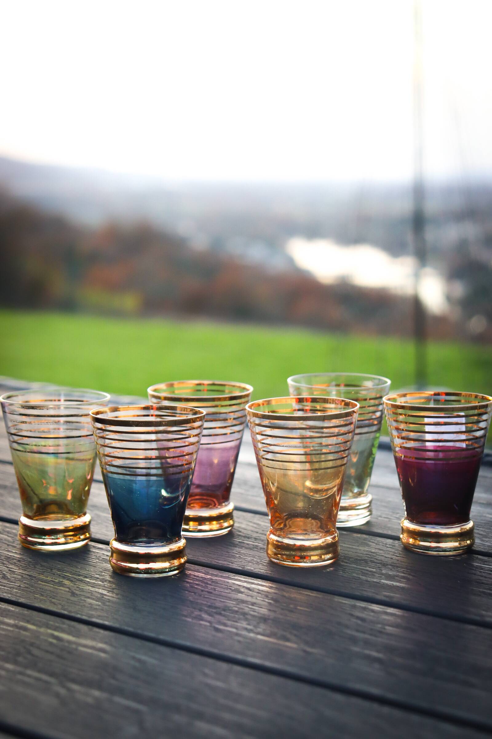 A vintage liqueur service in coloured and gold glass from the 1960s.