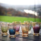 A vintage liqueur service in coloured and gold glass from the 1960s.