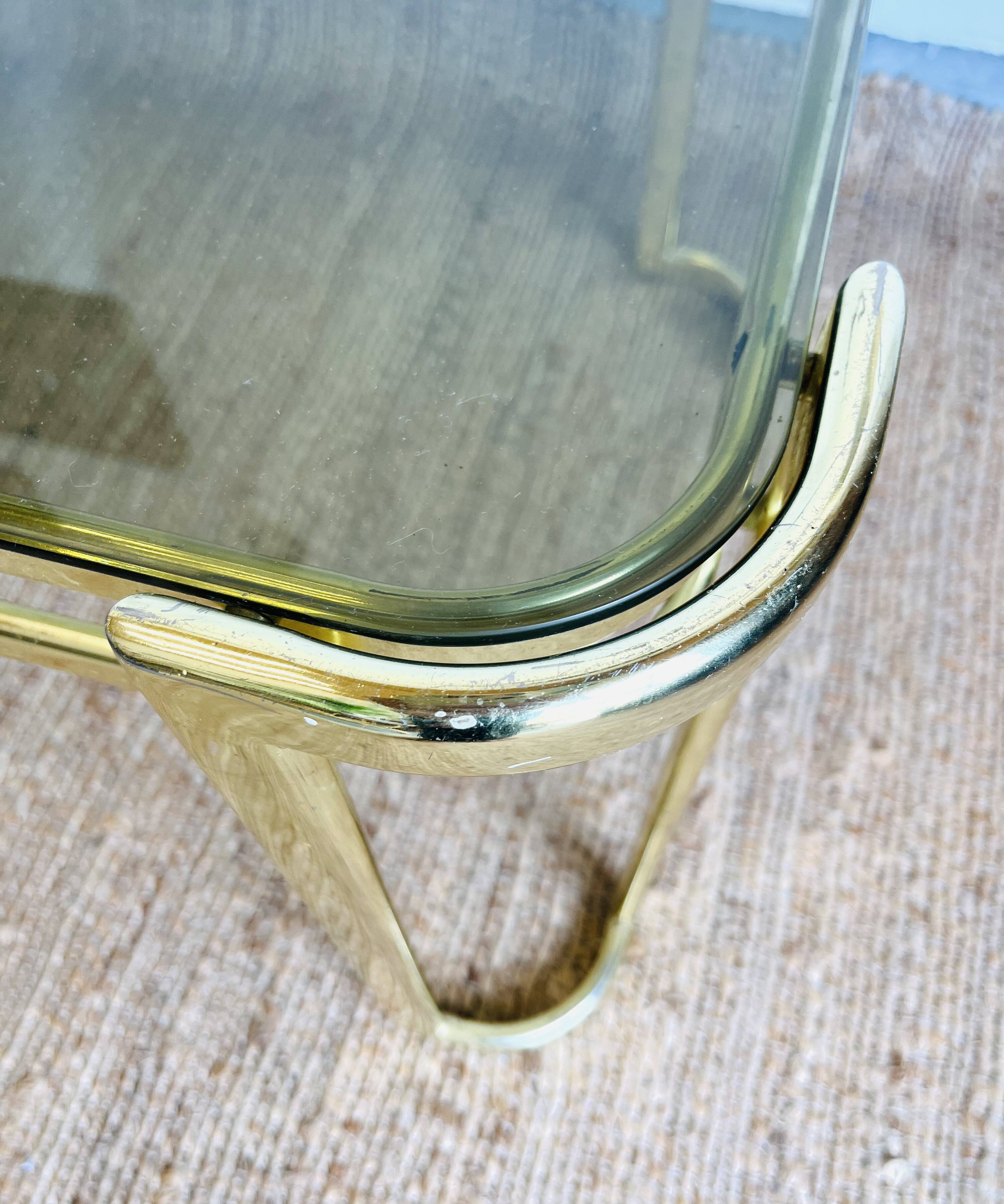 Gold metal and smoked glass coffee table – 1970s-624001