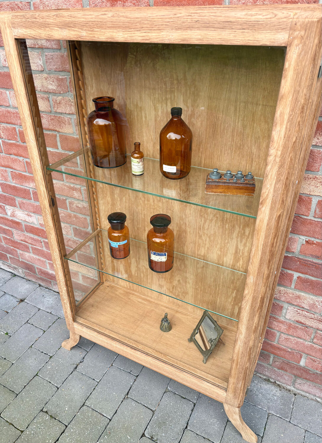 Restored antique oak display cabinet with glass shelves.
