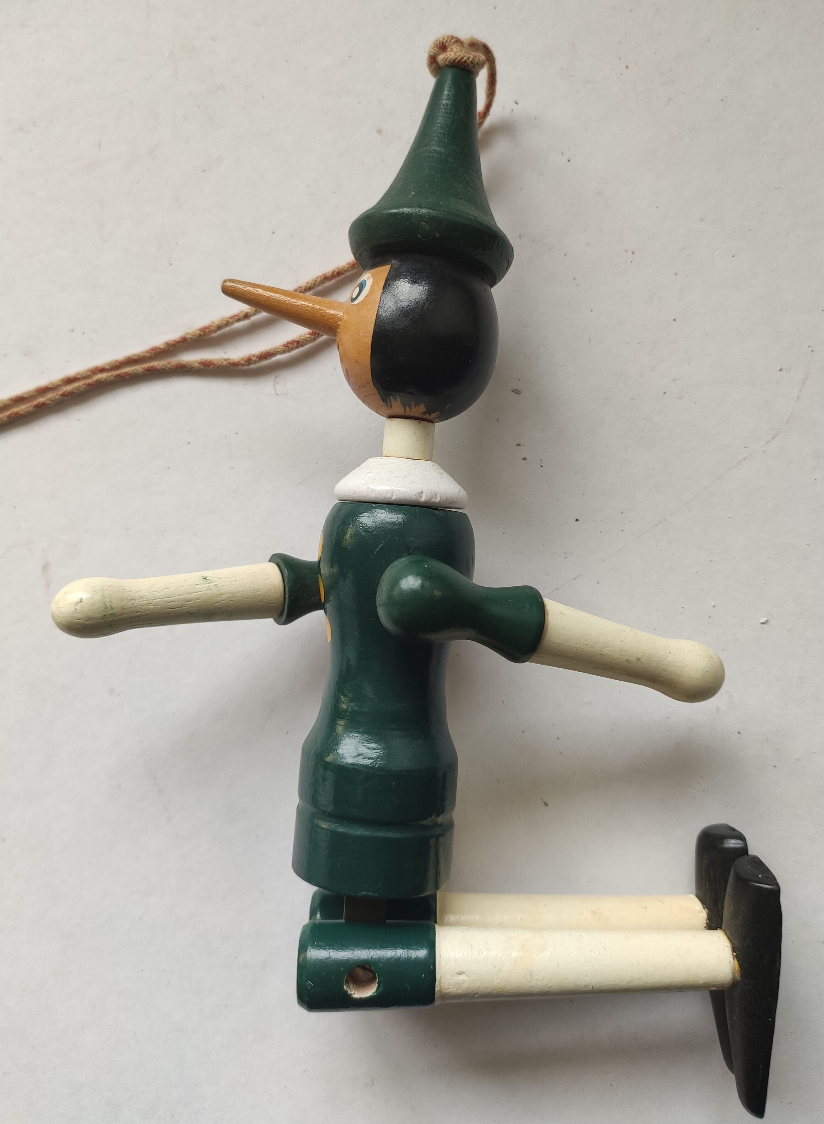 Green pinochio puppet in old wood