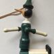 Green pinochio puppet in old wood