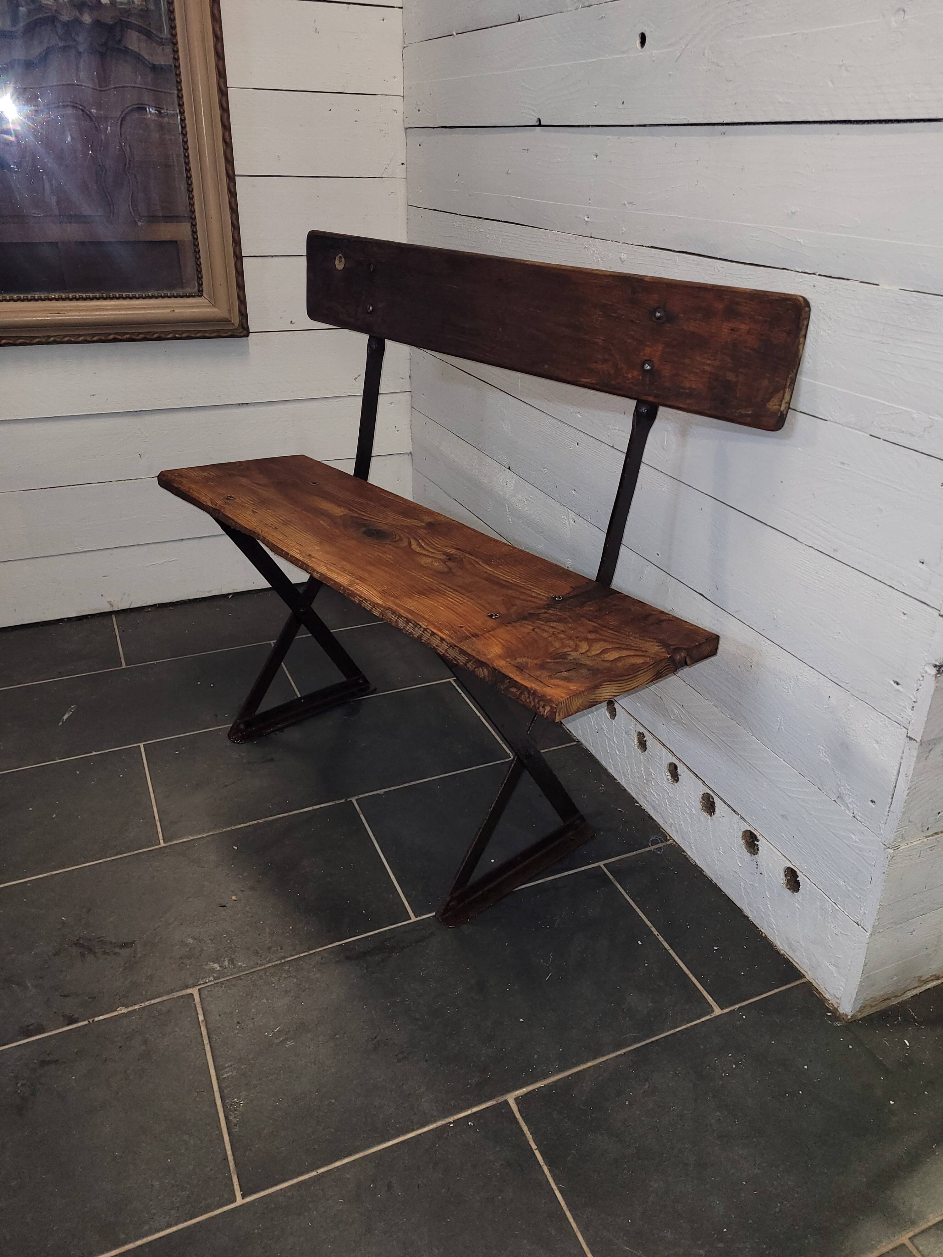 Old garden bench with iron legs and wooden seats