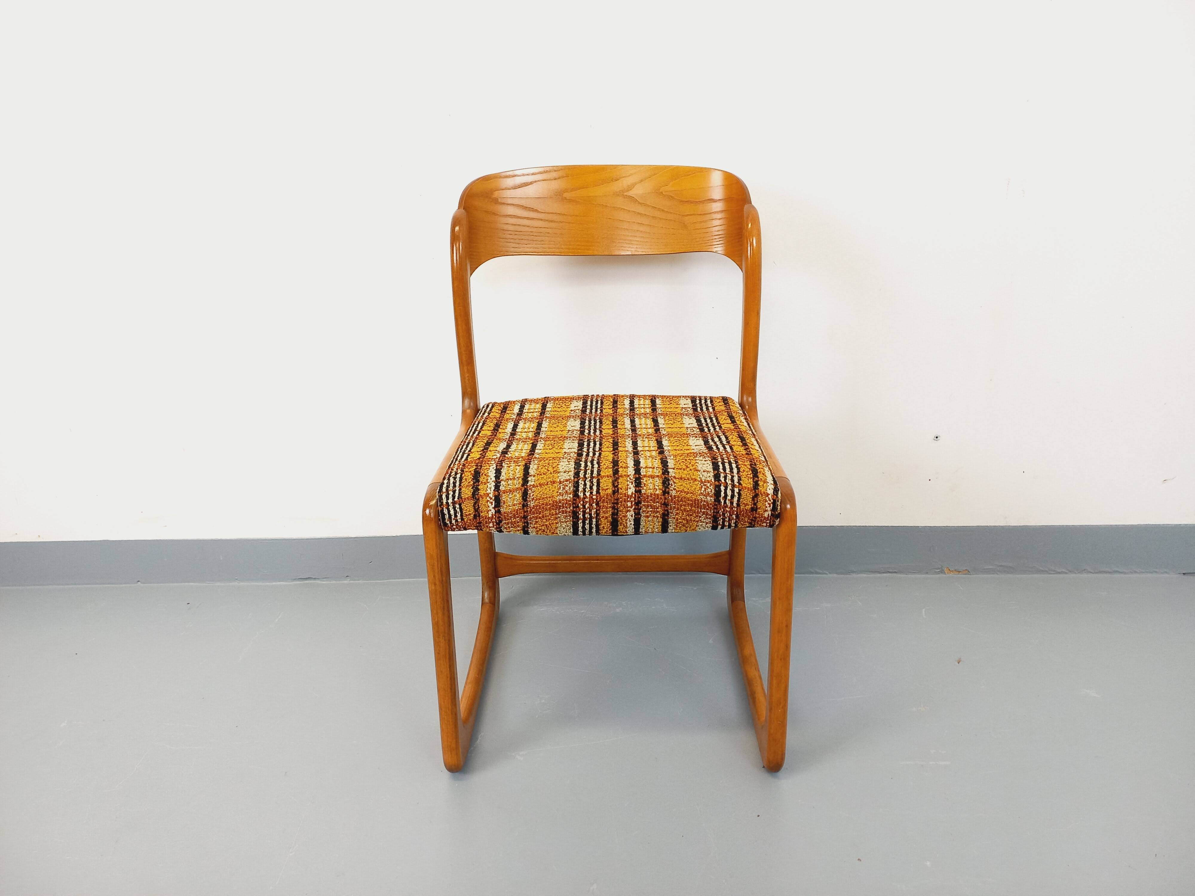 Vintage sled chair by Baumann in wood and wool fabric.