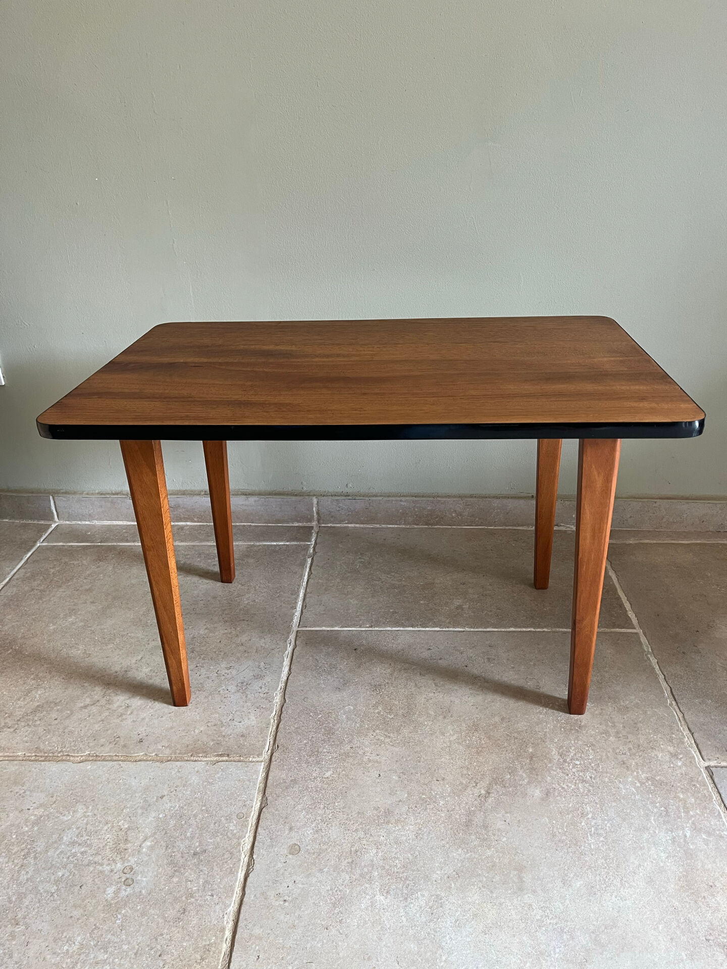 Mid-century coffee table with tapered legs.
