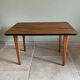 Mid-century coffee table with tapered legs.