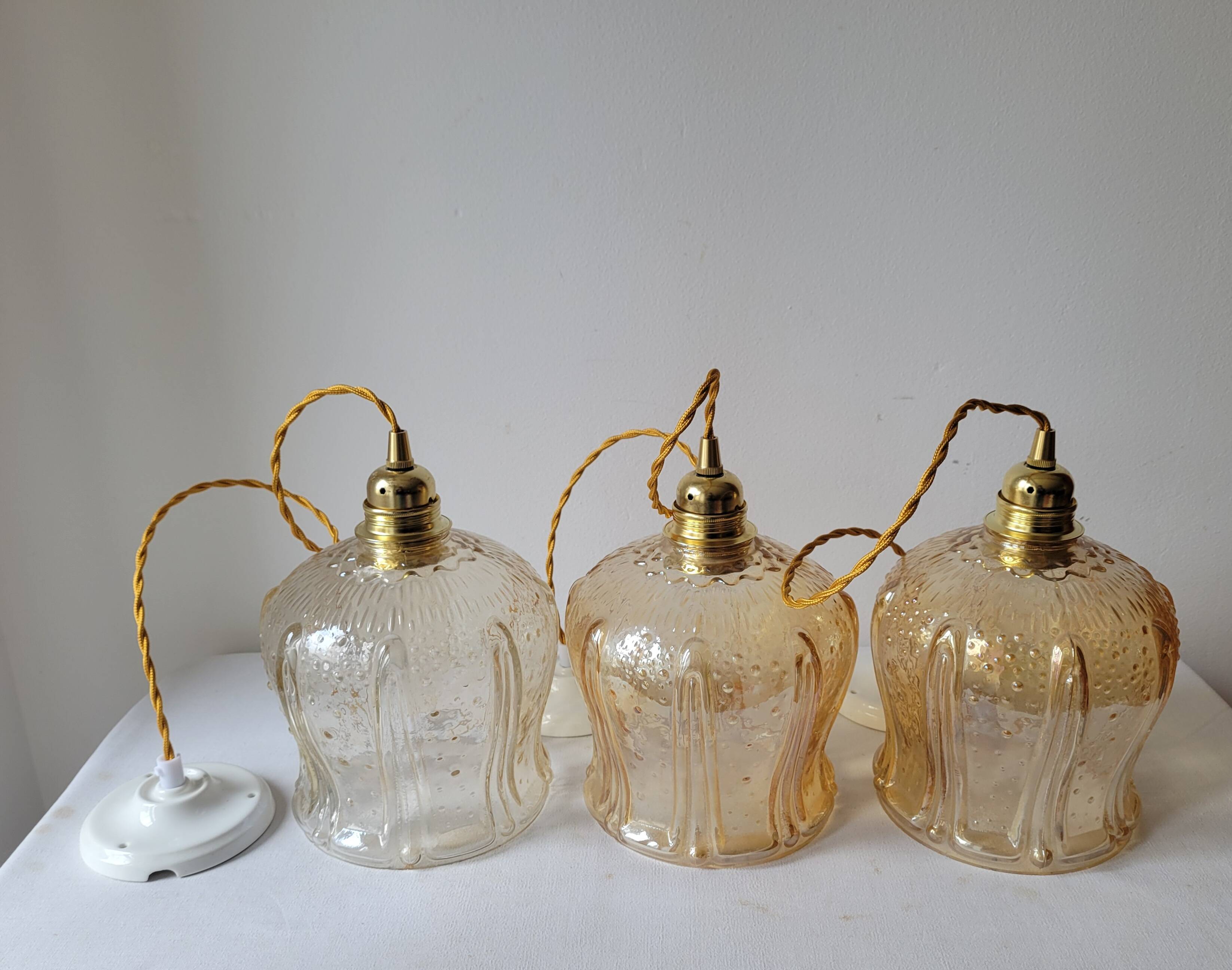 Trio of amber glass pendant lights