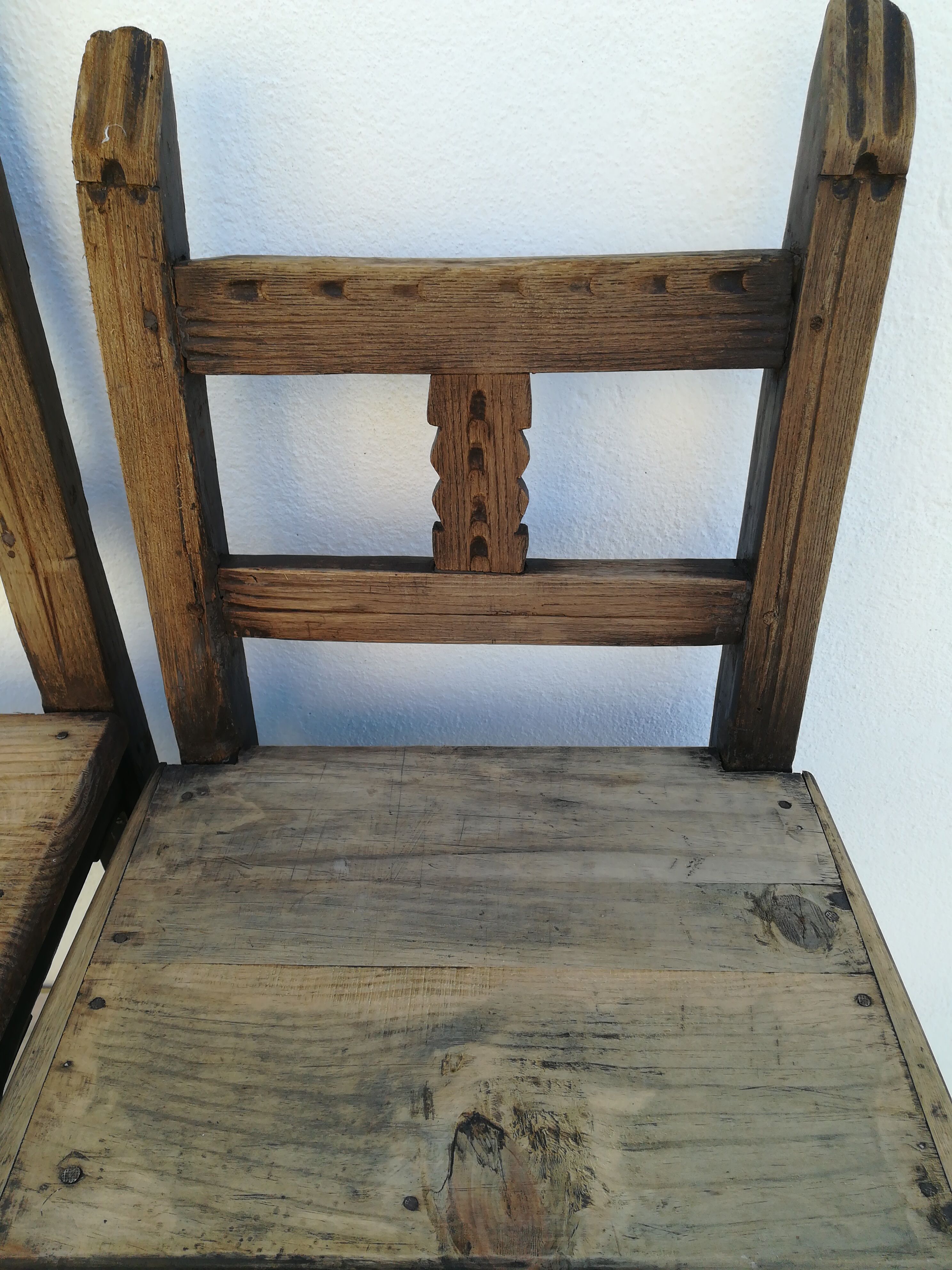 Pair of ethnic crude wooden chairs