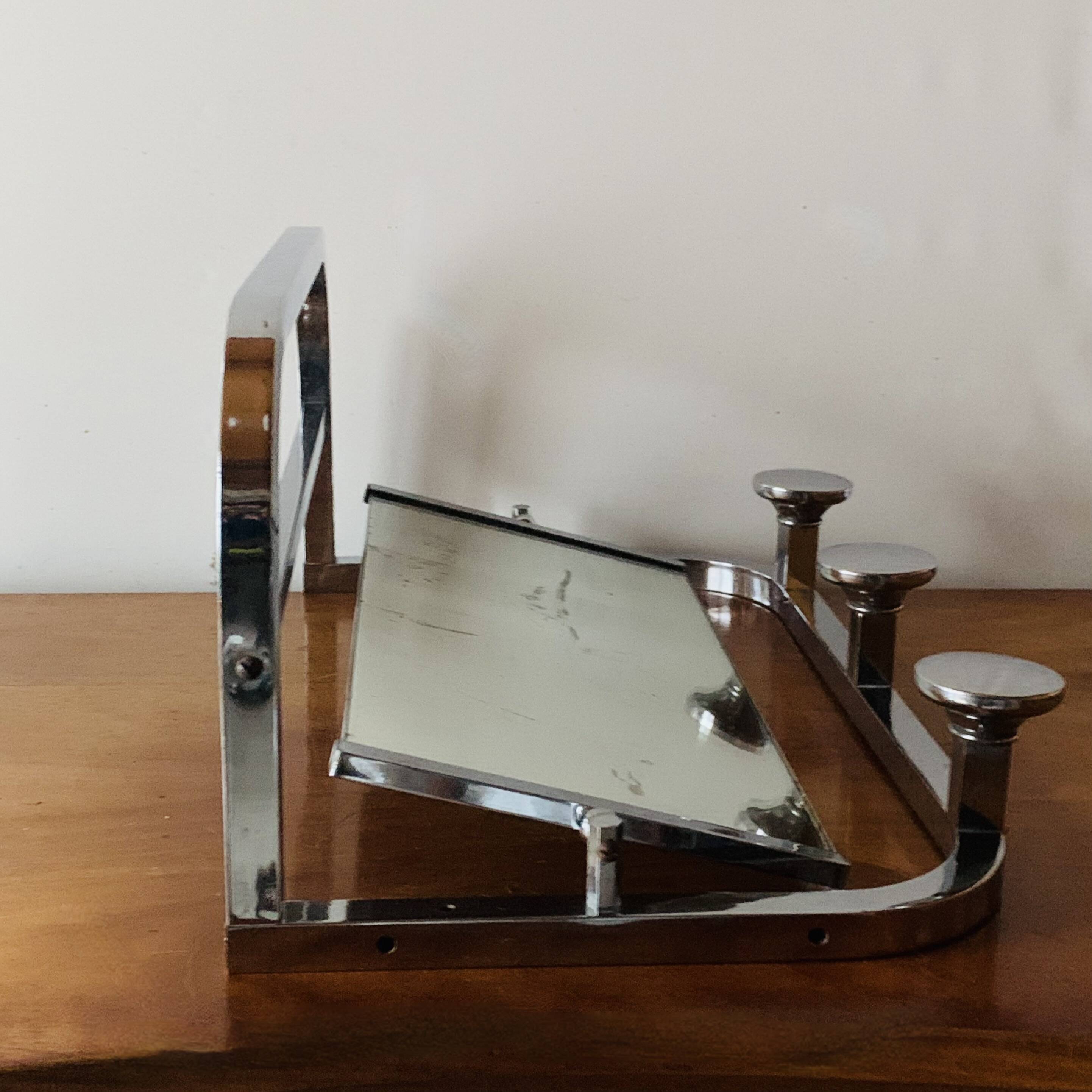 Vintage wall-mounted coat rack in chrome metal with integrated mirror and hat rack