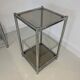 Bolster or end table in chrome steel with smoked window.