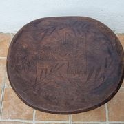 African monoxyle side table in carved wood with a curved top, 48x36 cm.