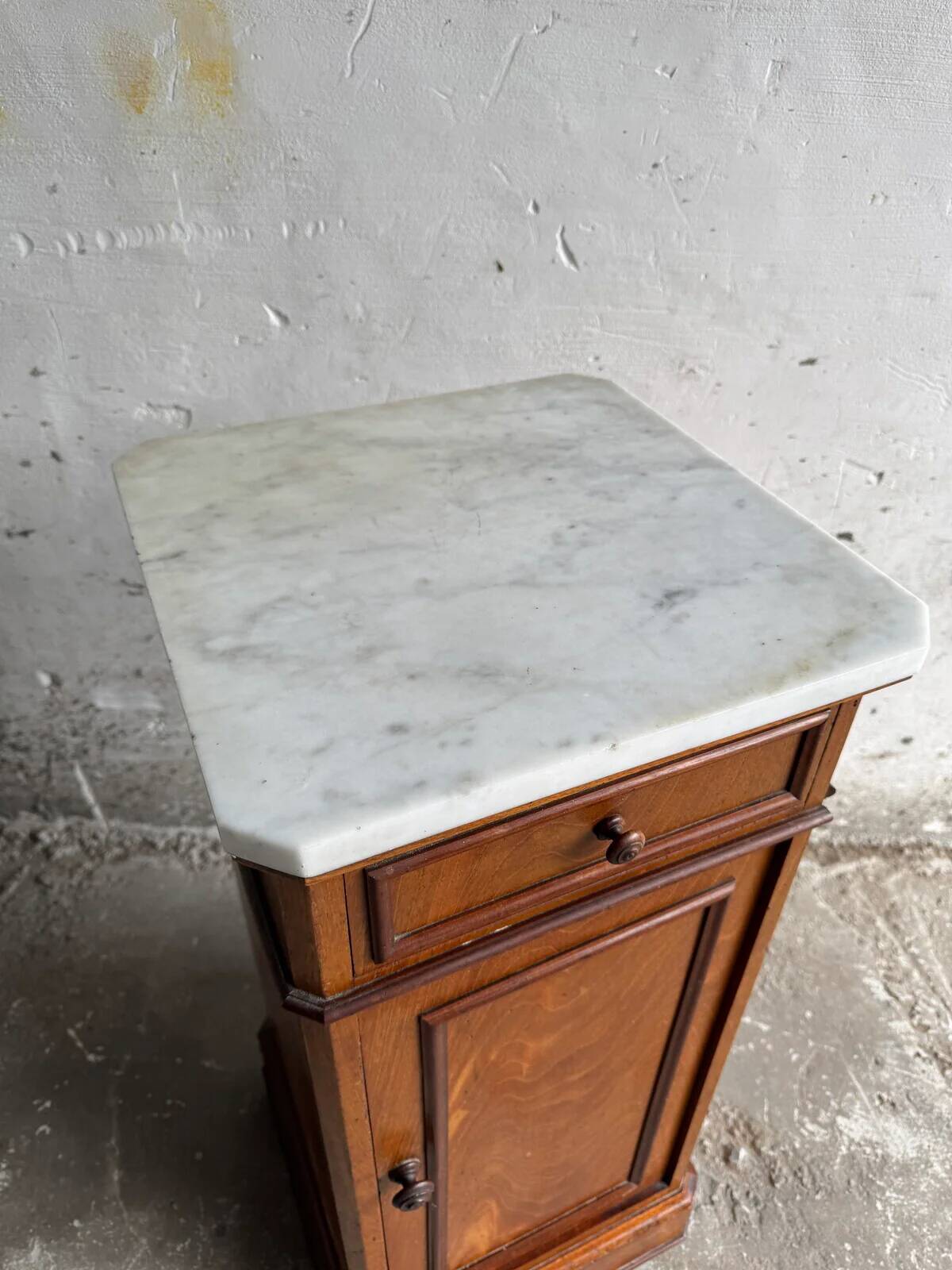 Vintage cabinet with white marble top and wooden body, drawer and door on wheels