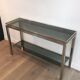 Beautiful console table in brushed metal with bluish glass shelves