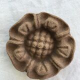 Pink sandstone paperweight in the shape of a rosette