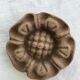 Pink sandstone paperweight in the shape of a rosette