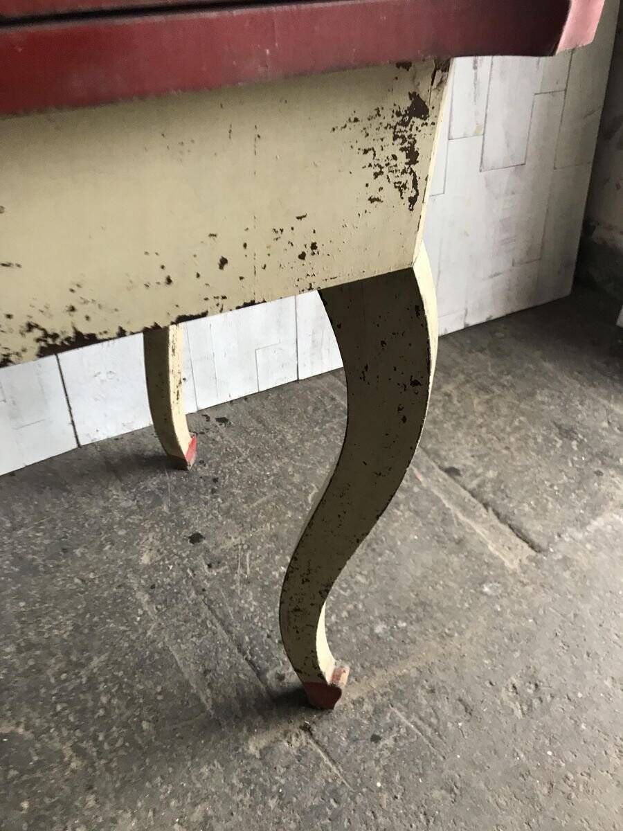 Rustic red and cream wooden dining table, moulded top, 1950s.