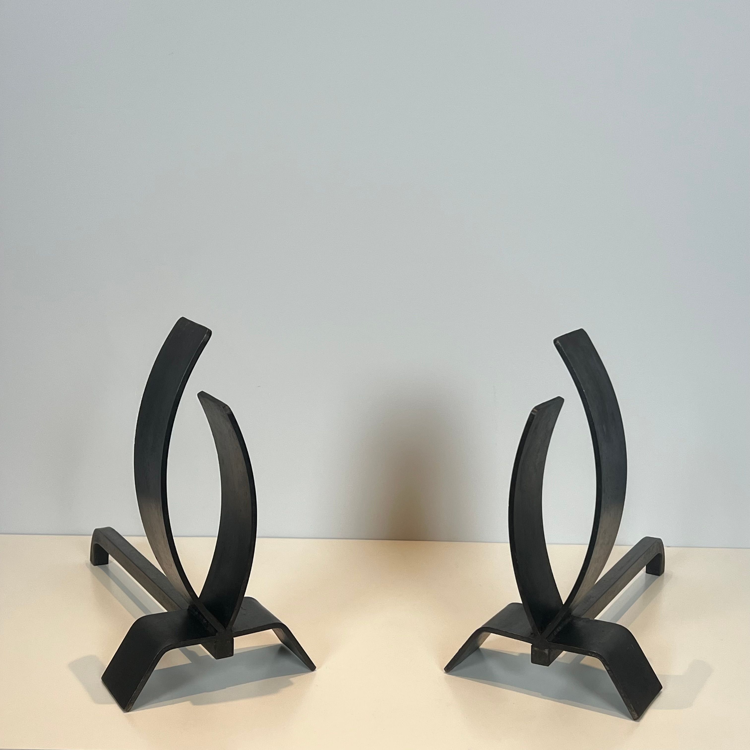 Pair of modernist andirons in steel and wrought iron