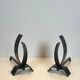 Pair of modernist andirons in steel and wrought iron