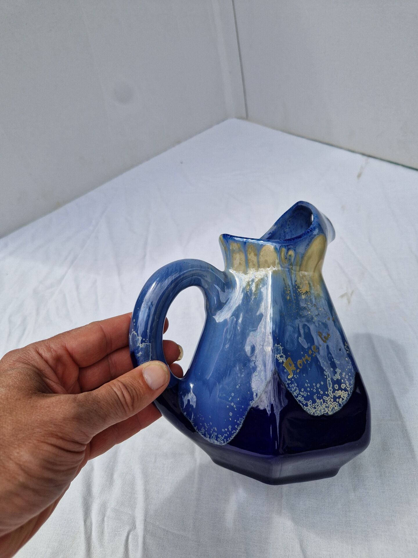 Old flamed ceramic jug. Very beautiful shades of blue, 6 sides.