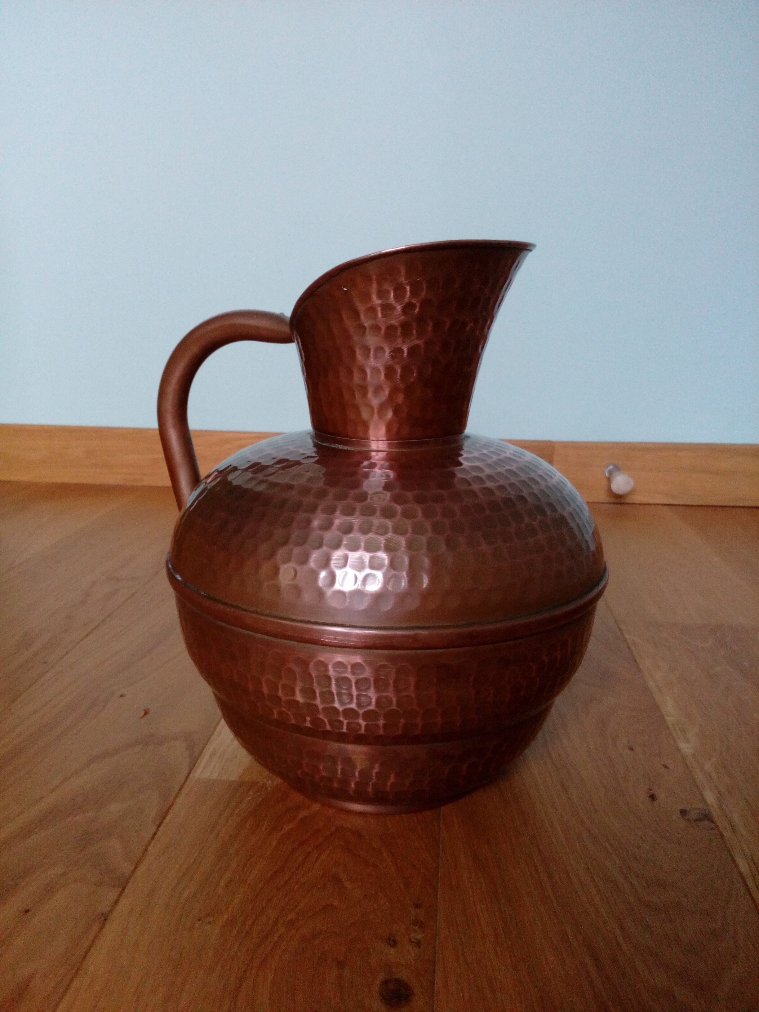 Dented copper vase or jug