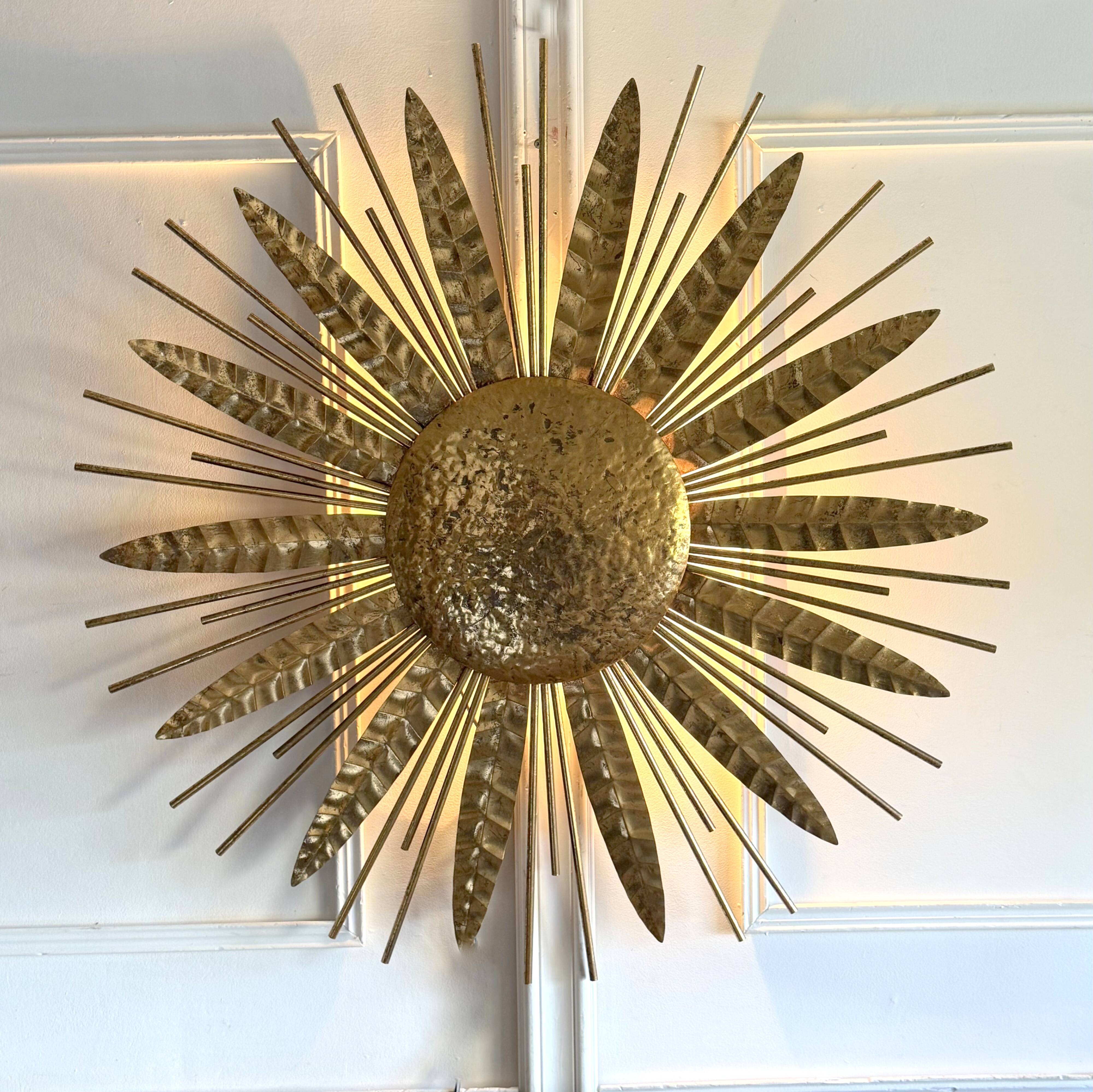 Large golden hammered metal sun wall light with a diameter of 90 cm from the year